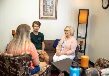 Social worker meeting with two people