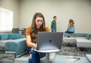 A student using a laptop. 