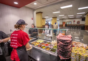 Behind the counter of a small cafe on campus