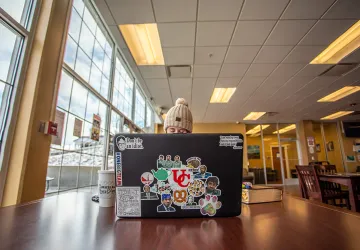 A girl studying on a snow day using a laptop.