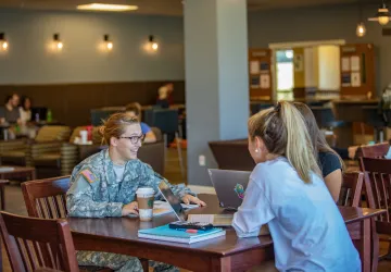 Military cadet speaking with fellow students