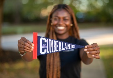 A Cumberlands student shows off the school's pennant 