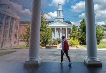 A student walks out of Grace Crum Rollins. 