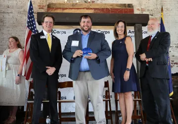 Campus Minister Jacob Ratliff is presented with a Governor's Service Award. 