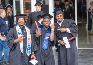 Three students celebrate their graduation at University of the Cumberlands.