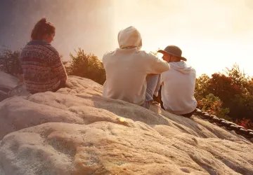 College students take in a sunrise at Chain Rock. 