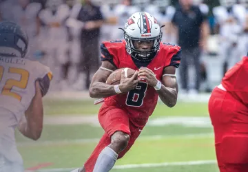 A Cumberlands running back follows his blockers on a play. 