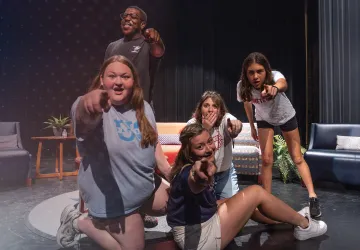 Students act out a scene in the university theatre. 