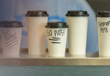 Several cups of coffee on display. 