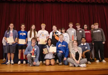 A group of students from the local community presented with a math award. 