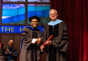 Dr. Sonal Sagar Boda receives his diploma from President Cockrum. 