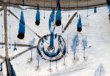 An aerial view of the globe statue on campus after a snow. 