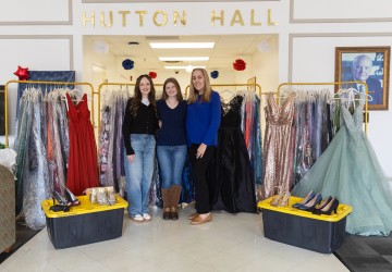 Cumberlands students Ella Edington, Abigail Wynn, and Caitlin Ball pose with prom dresses they have collected to give away to support local high school students. 