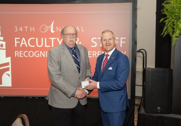 Dr. Tom Frazier is honored at his retirement by President Quentin Young. 