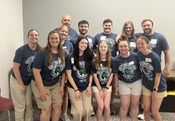 A group of physical therapy students pose together after a fitness event. 