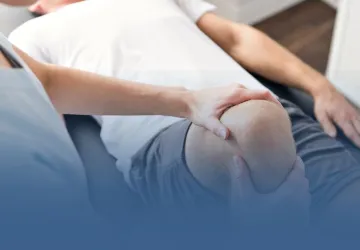 Physical Therapist Working on Patient Knee