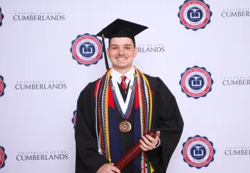Trey Jackson posing for a graduation photo. 