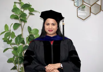 Dr. Saika Anumula posing in her cap and gown. 