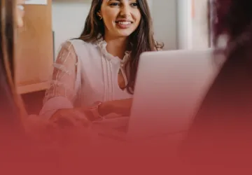 Communications Professional on Laptop with Clients