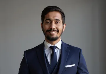 Rupesh Shirke poses in a blue suit. 