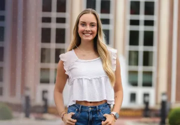 Commuter student Sydney Hurst posing in front of the library. 