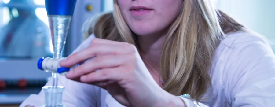 A chemist mixing chemicals