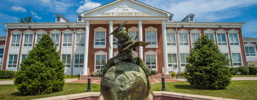 Bronze statue in front of a campus building