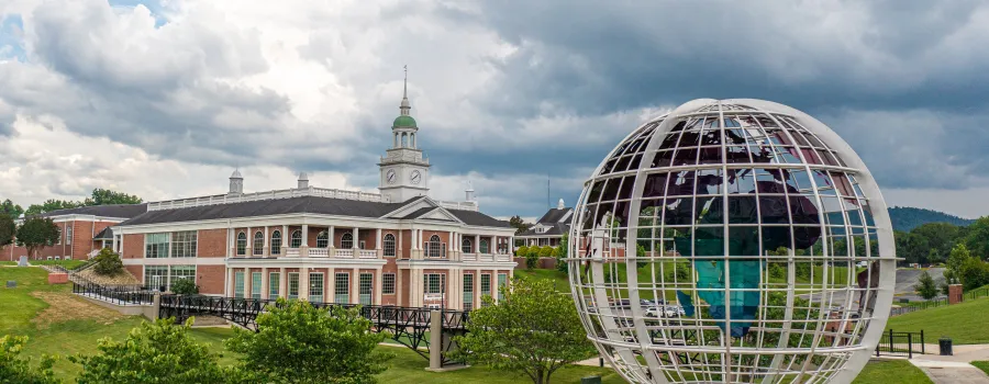 Large globe statue in front of campus building
