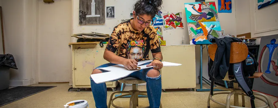 Student working on art project in the art classroom. 