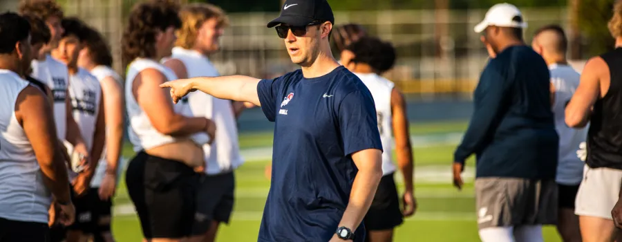 Football coach directing players