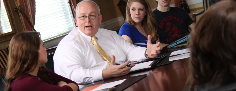 Professor teaching small group