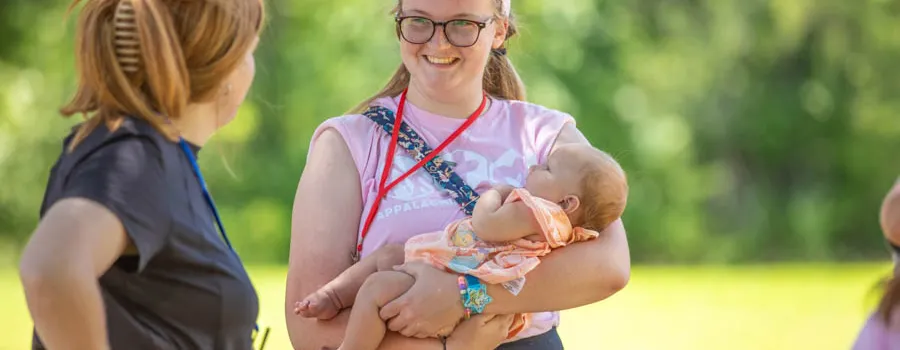 Young woman holding a baby