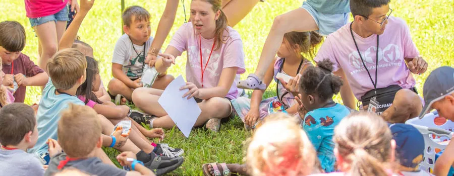 Children sitting in a circle outdoors