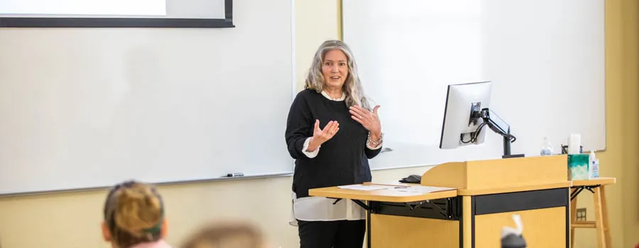 Woman giving presentation in front of a class