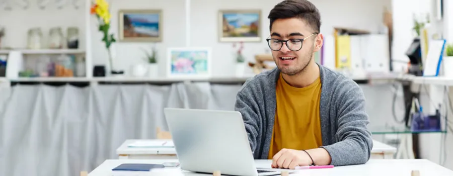 man using laptop in room
