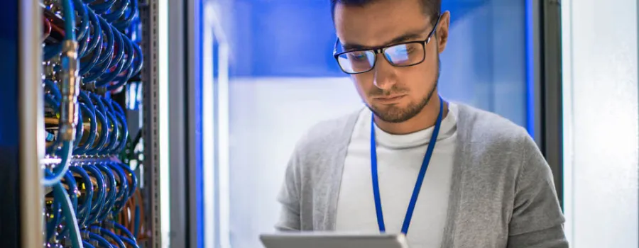 man in computer room looking at iPad