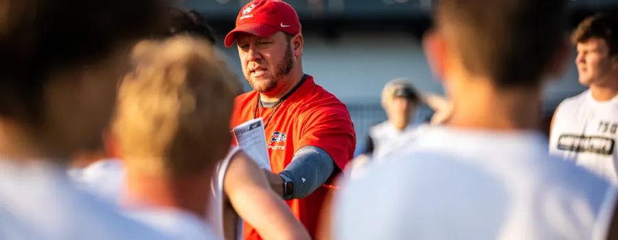 Football coach instructs players