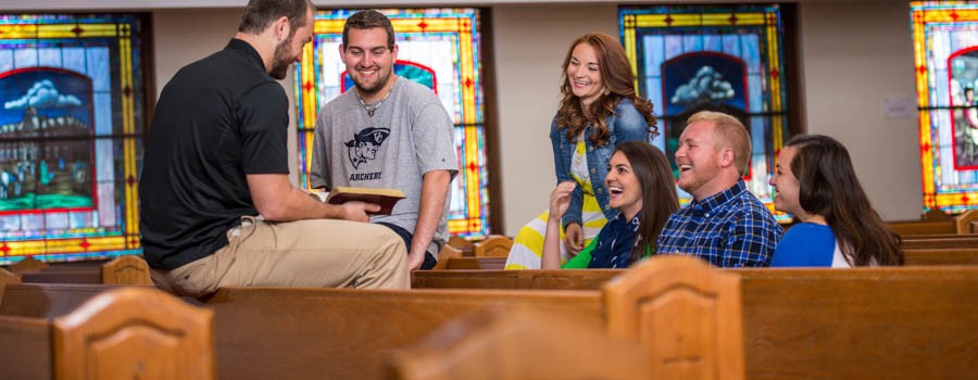 students discuss scripture inside church