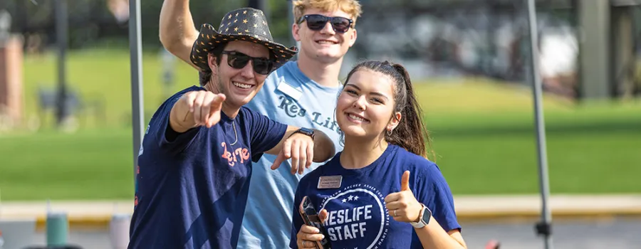 Students greeting others outdoors