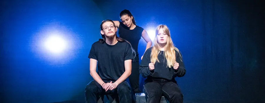 Actors on dark stage