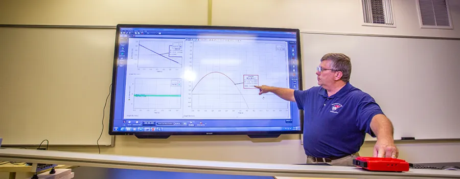 physics professor explaining a chart