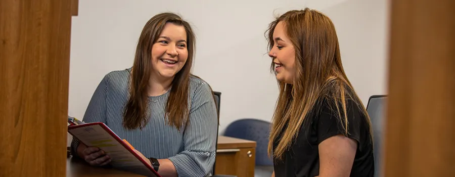 Adult talking with a student