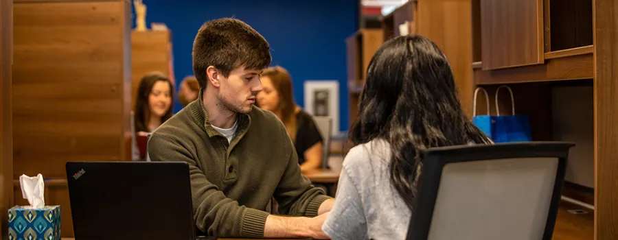 man helps lead a student through a question