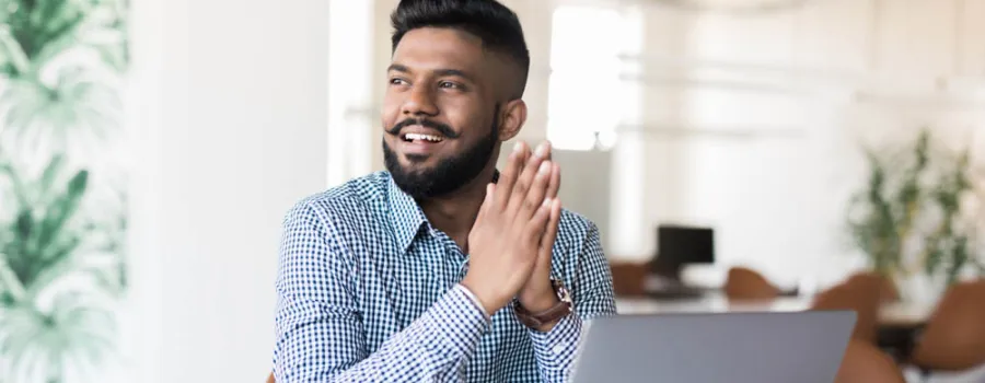 Man sitting at desk with laptop open