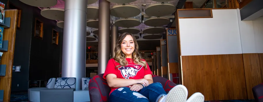 A student relaxes in the library lounge