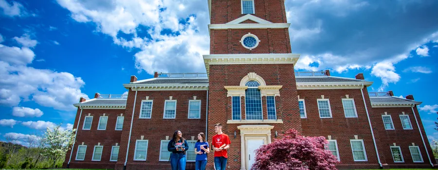 Students walk on campus near HSB