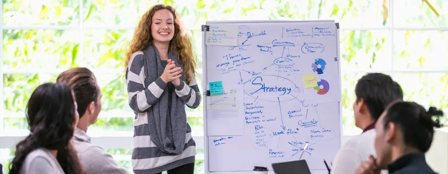 A young marketer discusses strategy with her colleagues. 