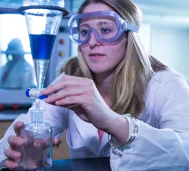 A chemist mixing chemicals