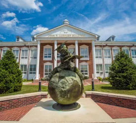 Bronze statue in front of a campus building