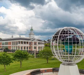 Large globe statue in front of campus building